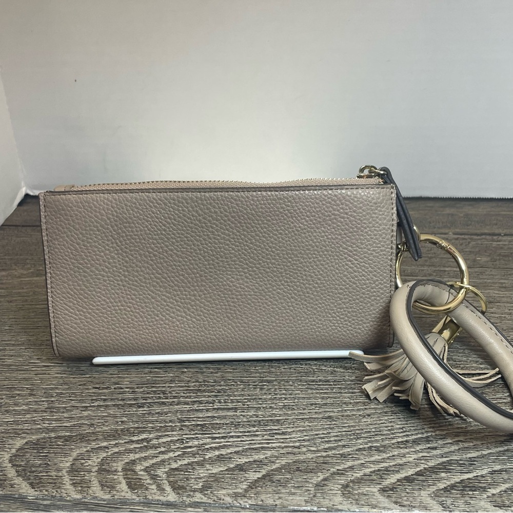 Nanette lepore Tan Clutch with Tassel Accent wristlet. Small flaw on corner - Picture 3 of 9